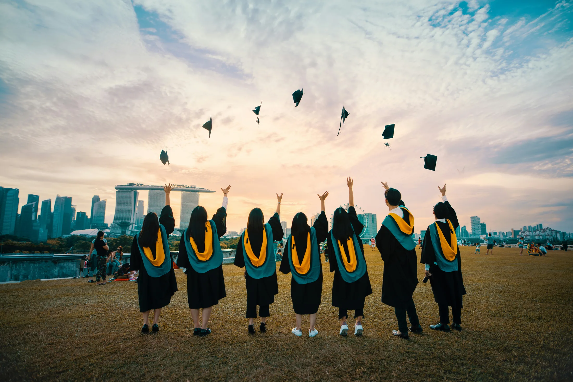 Graduates celebrating together outdoors